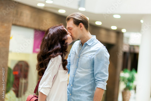 Young couple kissing in a mall