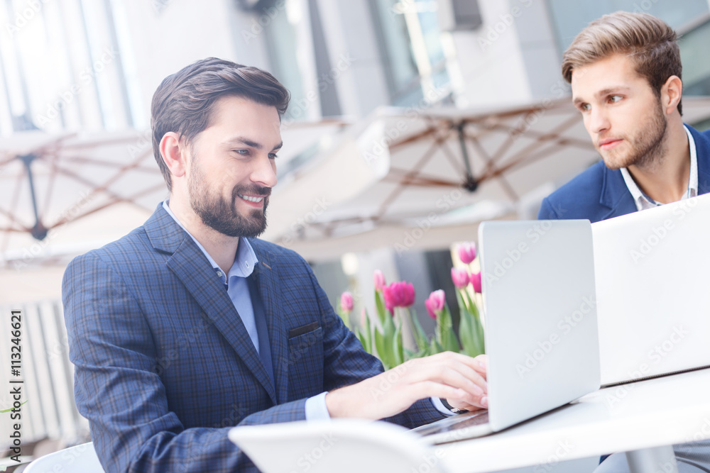 Attractive young businessmen have an appointment in restaurant Attractive young businessmen have an appointment in restaurant