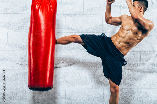 Obraz na plátně Young man kickboxing workout