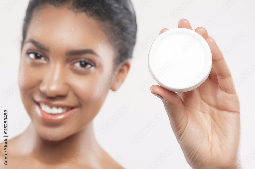 Attractive young african woman is caring of skin Attractive young african woman is caring of skin
