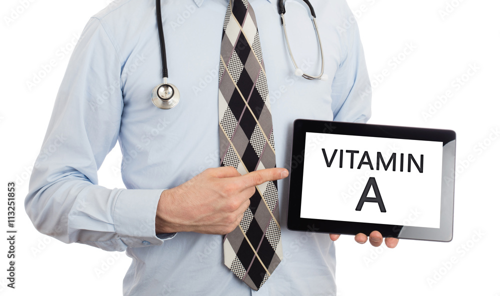Doctor holding tablet - Vitamin A Doctor holding tablet - Vitamin A
