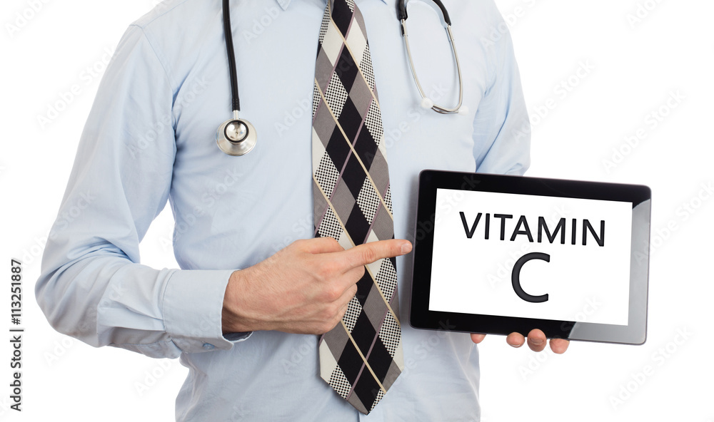 Doctor holding tablet - Vitamin C Doctor holding tablet - Vitamin C