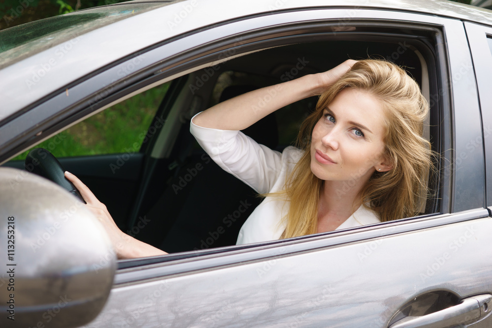 Smiling woman sitting in car