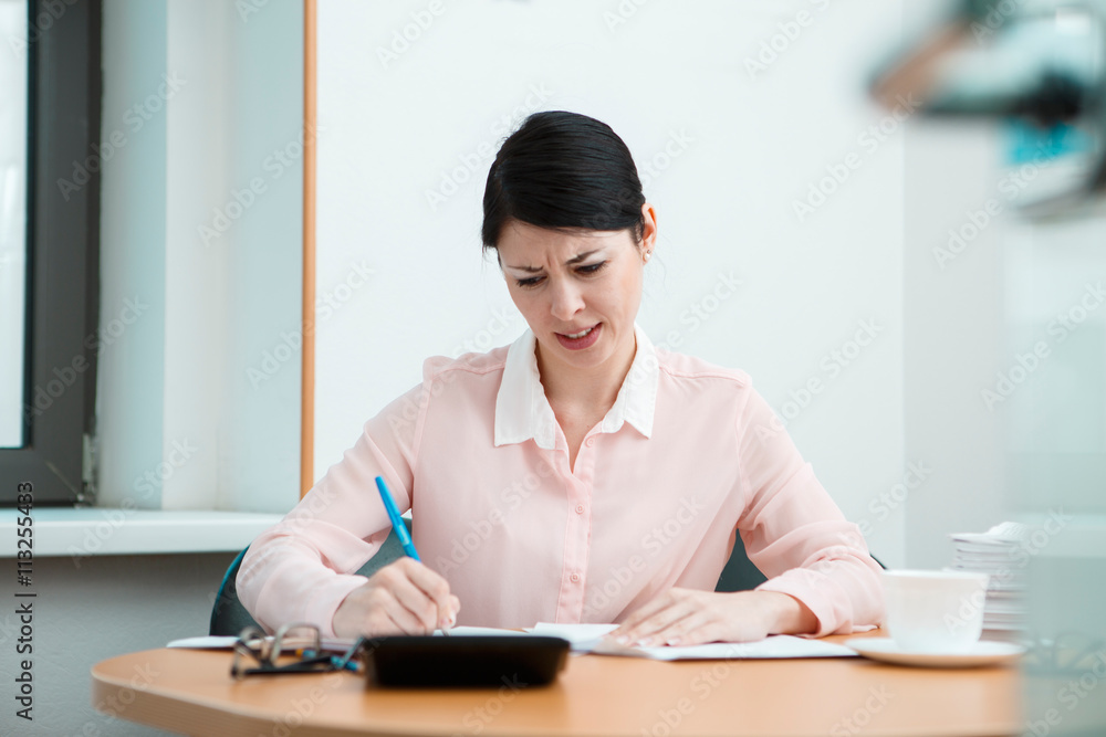 Woman in office with crumpled paper. Woman in office with crumpled paper.
