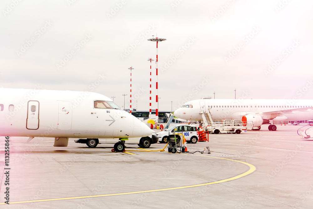 Fototapeta premium two side profile parked airplanes with windows of wide-body airplane.