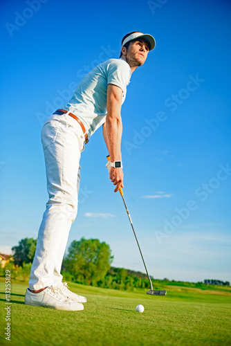 Golf player holding clud photo
