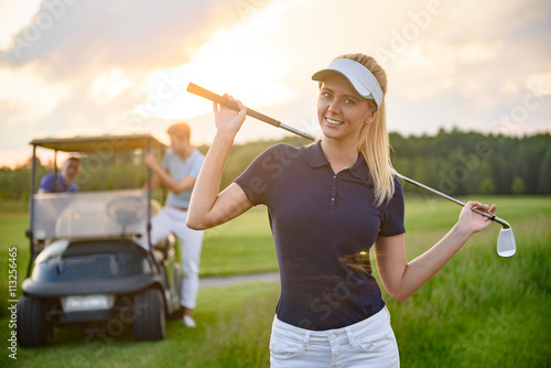 Young girl holding her golf club