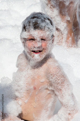 Children in the foam. Selective soft focus. A foam party