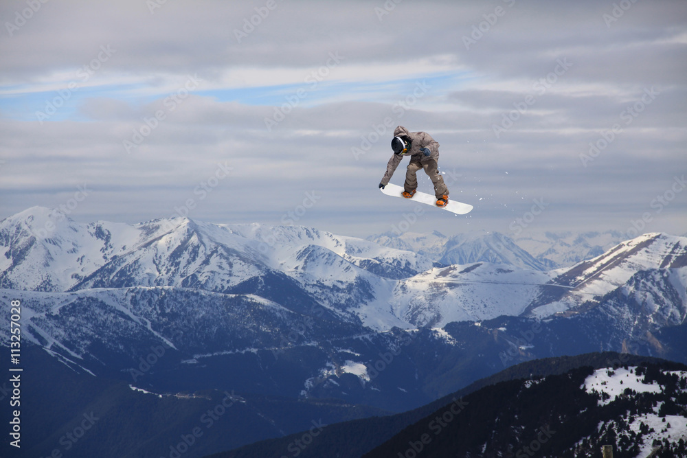 Snowboard rider jumping on mountains. Extreme freeride sport.