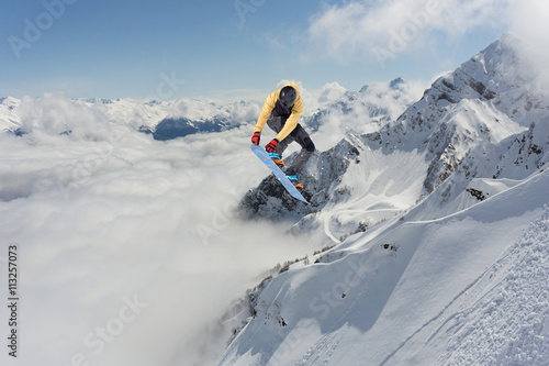 Canvas Print Snowboard rider jumping on mountains. Extreme freeride sport.