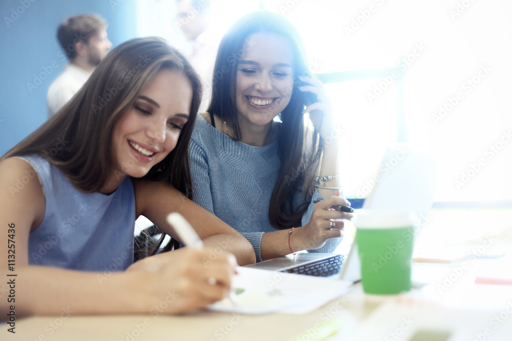 Two Businesswomen Having Informal Meeting In Office Two Businesswomen Having Informal Meeting In Office