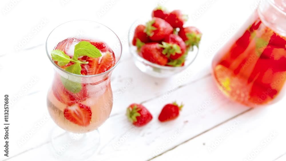 Strawberry iced lemonade on the white wooden table Strawberry iced lemonade on the white wooden table