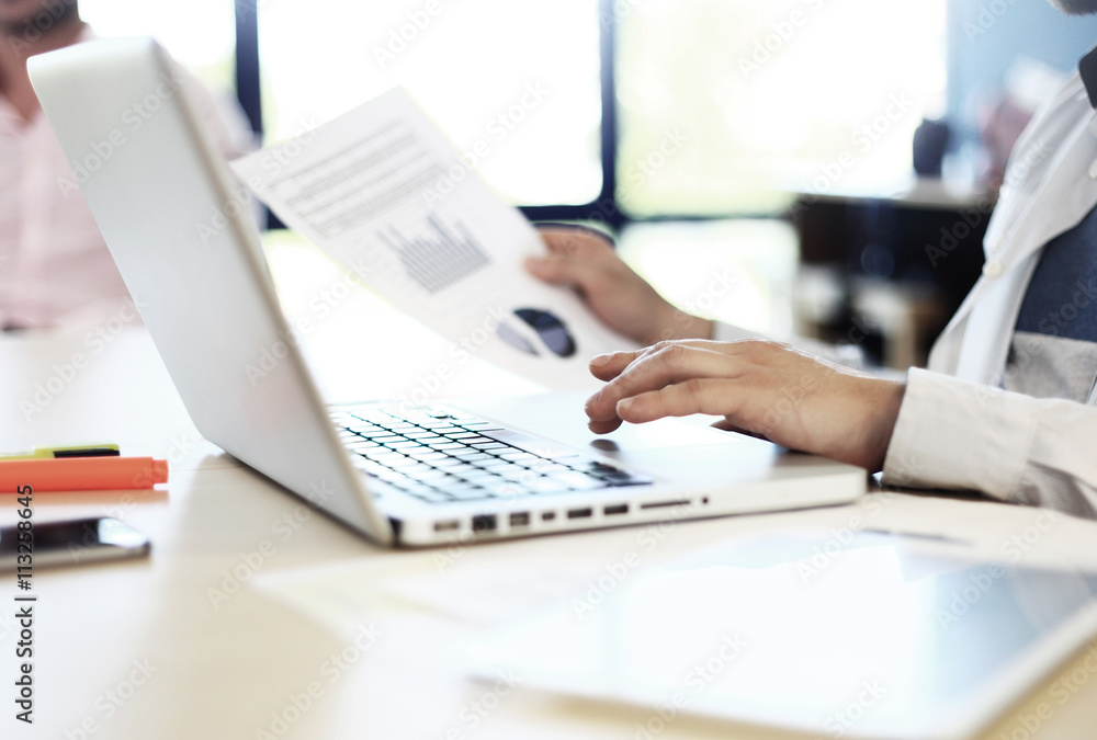 Young man working with laptop, man hands on notebook computer, business person at workplace Young man working with laptop, man hands on notebook computer, business person at workplace