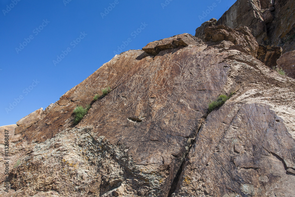 Buddha carved in a rock in Tamgaly Tas - An Unesco World Heritage Site in Kazakhstan - Central Asia Buddha carved in a rock in Tamgaly Tas - An Unesco World Heritage Site in Kazakhstan - Central Asia
