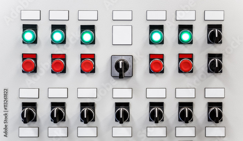 Control panel of industrial equipment with name plates, switches