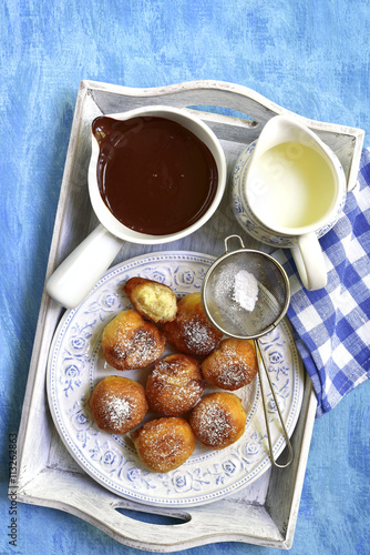 Vanilla doughnuts with chocolate sauce. photo