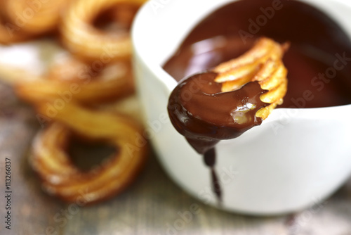 Traditional mexican dessert churros with chocolate sause.