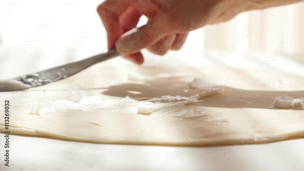 puff-pastry-manually-making-with-fat-spreading-over-dough-with-knife-4k