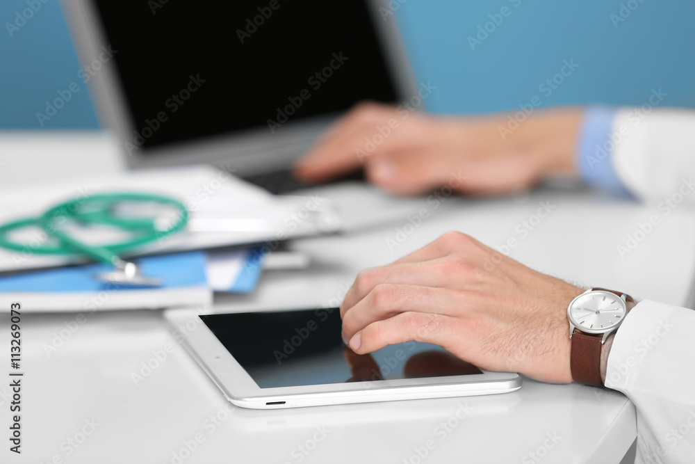 Fototapeta premium Doctor working on a tablet in hospital
