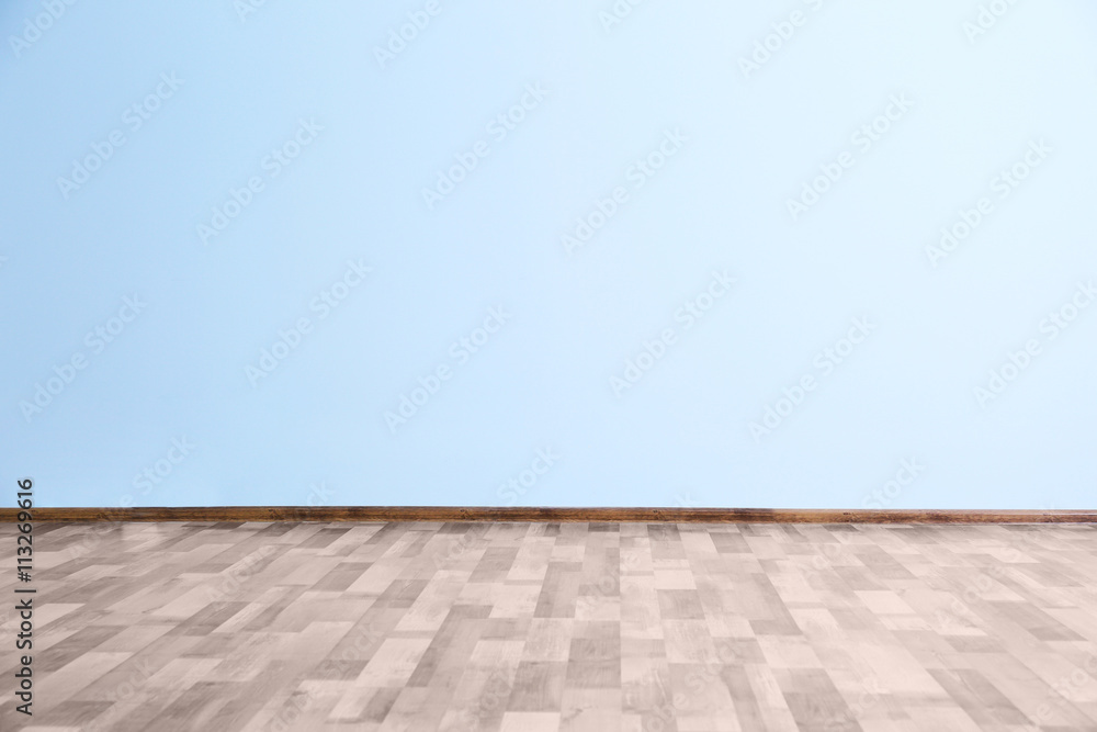 Fototapeta premium Empty room with blue wall and wooden floor