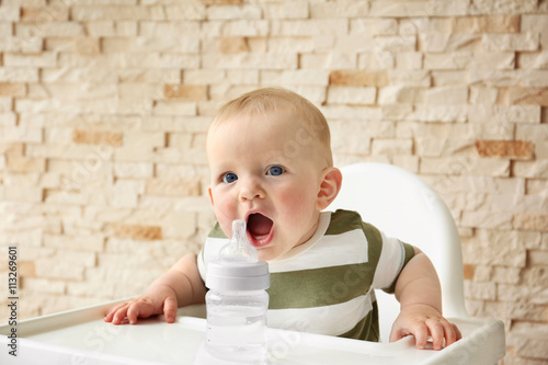 Baby drinking water in a ch...