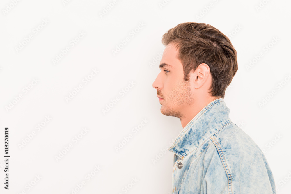 Fototapeta premium Side view of young hansome man isolated on white background