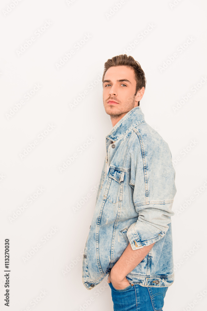 Side view portrait of stylish guy in jeans jacket holding hand i Stock  Photo | Adobe Stock