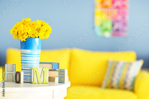 Beautiful bouquet of yellow narcissus on table