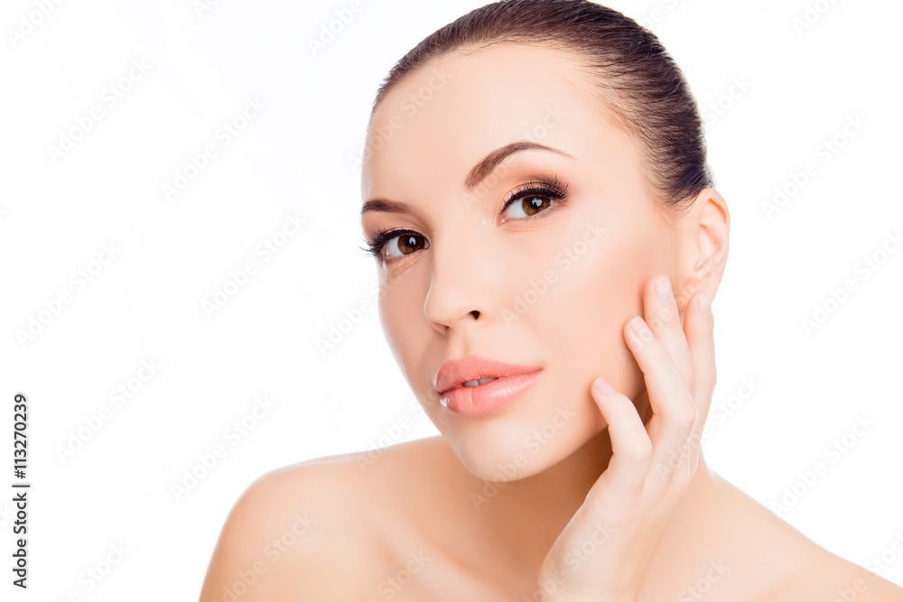 Portrait of beautiful young woman expertising skin on her face