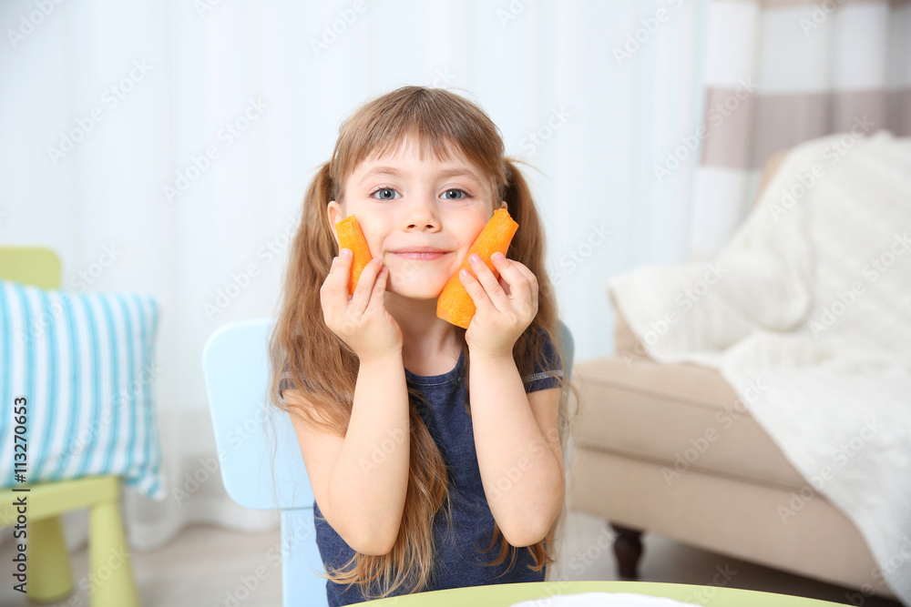 Little girl with carrot in the living room Little girl with carrot in the living room