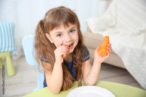 Little girl with carrot in ...