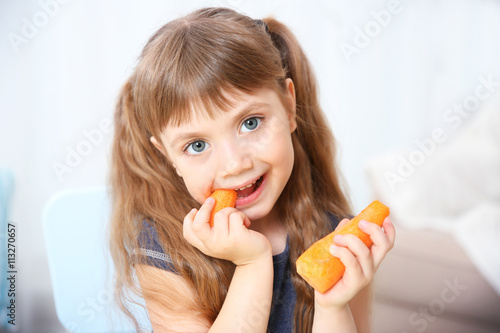 Little girl with carrot in ...