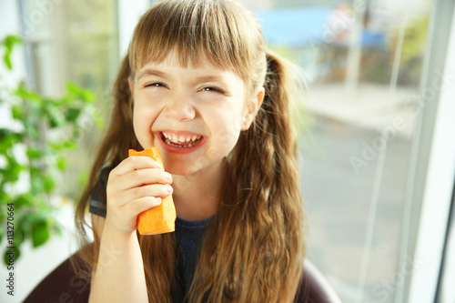 Little girl with carrot on ...