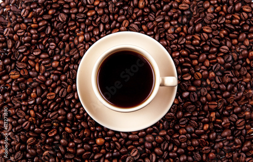 Coffee beans in coffee cup isolated on white