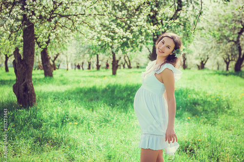 Pregnant woman in the apple orchard