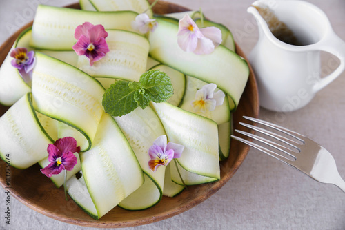 Zucchini salad with edible flowers  summer vegan salad