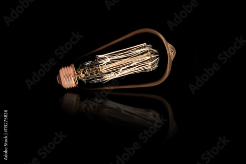 Incandescent light bulb on black background