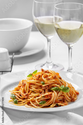 italian spaghetti bolognese on plain white plate