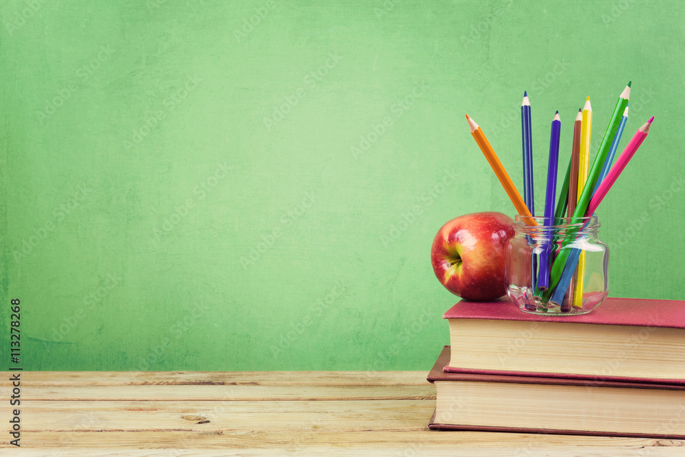 Back to school background with books, color pencils and apple over green  wallpaper Stock Photo | Adobe Stock
