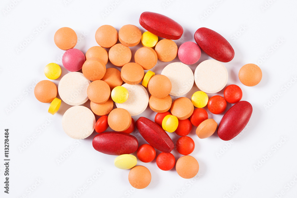 Colorful medical tablets and capsules on white background, health care concept Colorful medical tablets and capsules on white background, health care concept