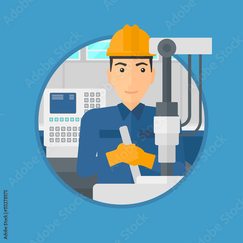 Man working on industrial drilling machine.