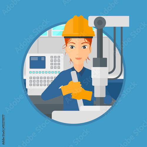 Woman working on industrial drilling machine.