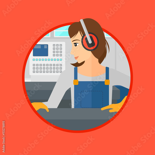 Woman working on metal press machine.