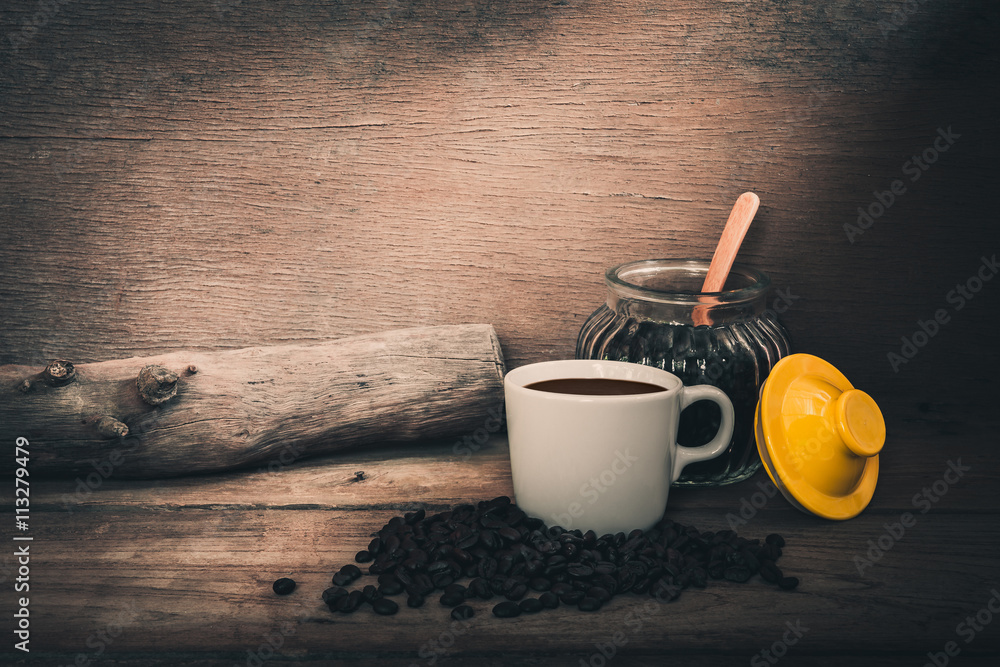 Cup coffee and beans on wooden table over grunge background Cup coffee and beans on wooden table over grunge background