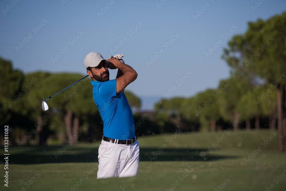 pro golfer hitting a sand bunker shot