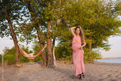 pragnant woman on the beach photo