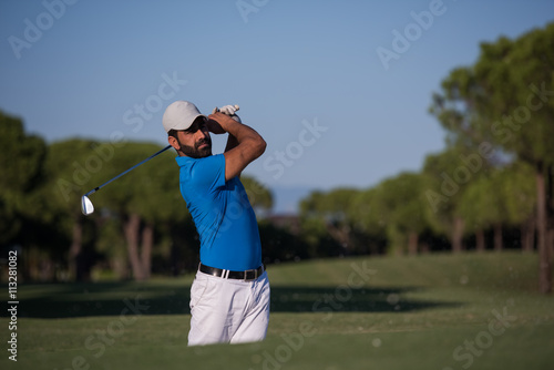 pro golfer hitting a sand bunker shot