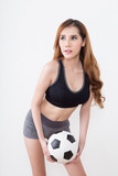 Young sexy woman with soccer ball