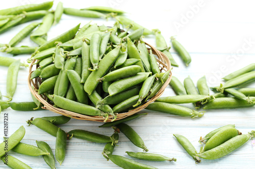 Green peas on a blue wooden table