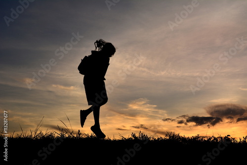 Silhouette a girl jumping at sky sunset